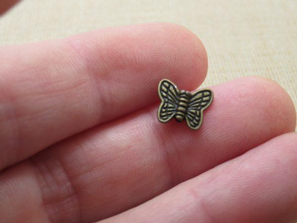 Perles papillon bronze 10mm en métal